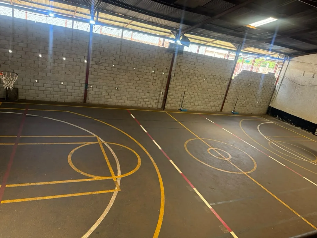 Indoor sports court at District Arena, shown with basketball hoops and court markings